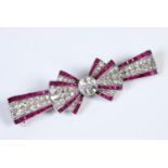 An Art Deco diamond and ruby bow brooch, and a Tessiers, London, box Report by RB The property of