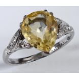 An 18ct white gold and platinum pear shaped yellow sapphire ring, with diamonds to the shoulders,