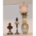 A late 19th/early 20th century brass oil lamp, with green glass well and eight others (9) All shades