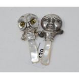 A novelty silver owl rattle, with a mother of pearl handle, and a similar (2)