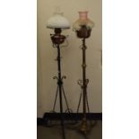 A late 19th/early 20th century brass and cast metal standard lamp, 155 cm, and another (2)