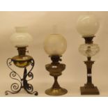 A late 19th/early 20th century brass and cast metal oil lamp, with white glass shade, and five