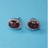 A pair of 18ct white gold, garnet and diamond earrings, approx. 2.2ct