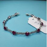 A Burmese ruby and diamond fancy link bracelet, in a white coloured metal setting Ten rubies, 18