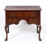 A 19th century oak lowboy, with long drawer above two short drawers, on cabriole legs and pad