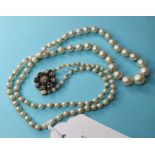 A single row graduated cultured pearl necklace, the clasp set rough cut diamonds, lacking a stone