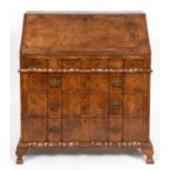 An 18th century Continental walnut bureau, the fall front revealing a fitted interior and a well,