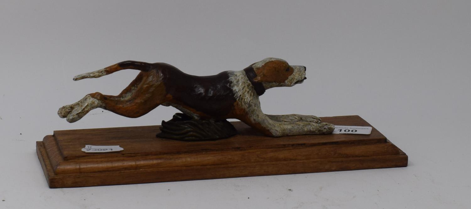 A painted bronze running dog paperclip, on an oak base, 28 cm wide Report by RB Modern