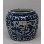 A Chinese pottery jardiniere, decorated fish and foliage in underglaze blue, 17.5 cm high firing