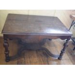 A 17th century style table, with oyster cut veneer, on turned legs joined by a shaped X stretcher,