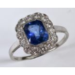An 18ct white gold, sapphire and diamond cluster ring, approx. ring size S½