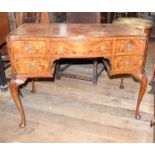 A 1920's burr walnut kneehole desk, of five drawers, 77 x 104 cm