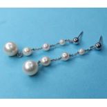 A pair of white gold and graduated cultured pearl drop earrings