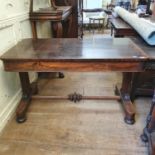 An early Victorian rosewood library table, having a frieze drawer on end supports with sledge feet