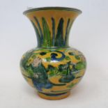 A Chinese yellow ground vase, decorated figures and foliage in green enamel, rim chipped, 12 cm high