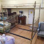A late Victorian/Edwardian brass four poster bed, with turned finials, some repairs, 230 cm high