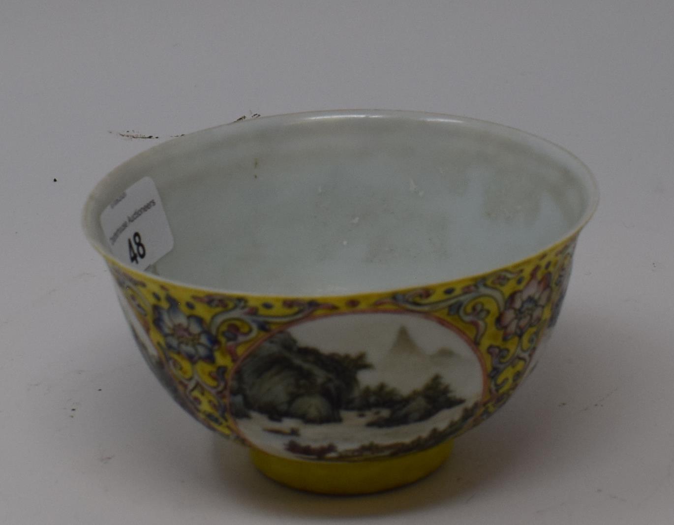 A Chinese porcelain medallion bowl, decorated vignettes of mountain scenes on a yelllow ground