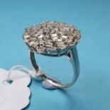 A white gold ring, set baguette cut diamonds, approx. ring size S