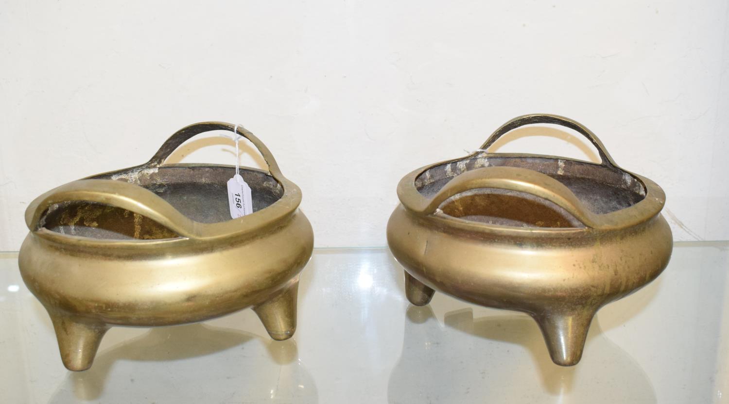 A pair of Chinese brass censors, with loop handles and seal type marks, 23.5 cm wide x 15.5 cm high