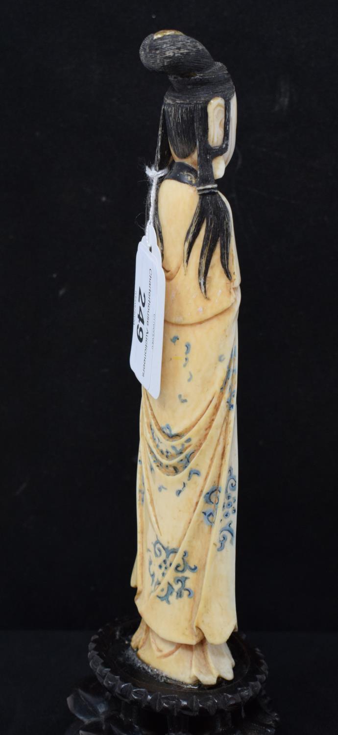 An early 20th century Chinese carved, stained and painted ivory figure, of a lady holding beads - Image 3 of 6