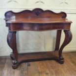 A Victorian serpentine front oak console table, on carved cabriole front legs, with knurl feet, on a