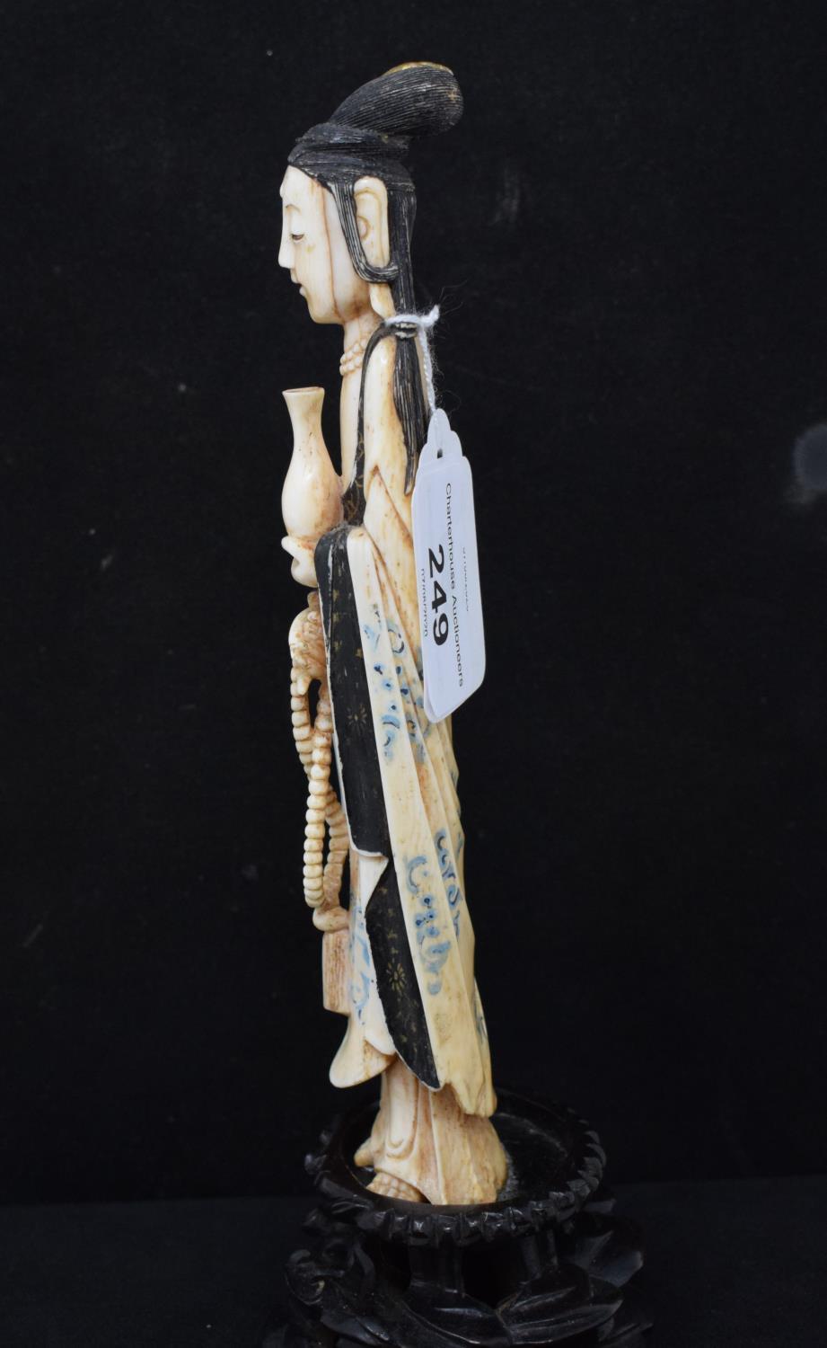 An early 20th century Chinese carved, stained and painted ivory figure, of a lady holding beads - Image 2 of 6