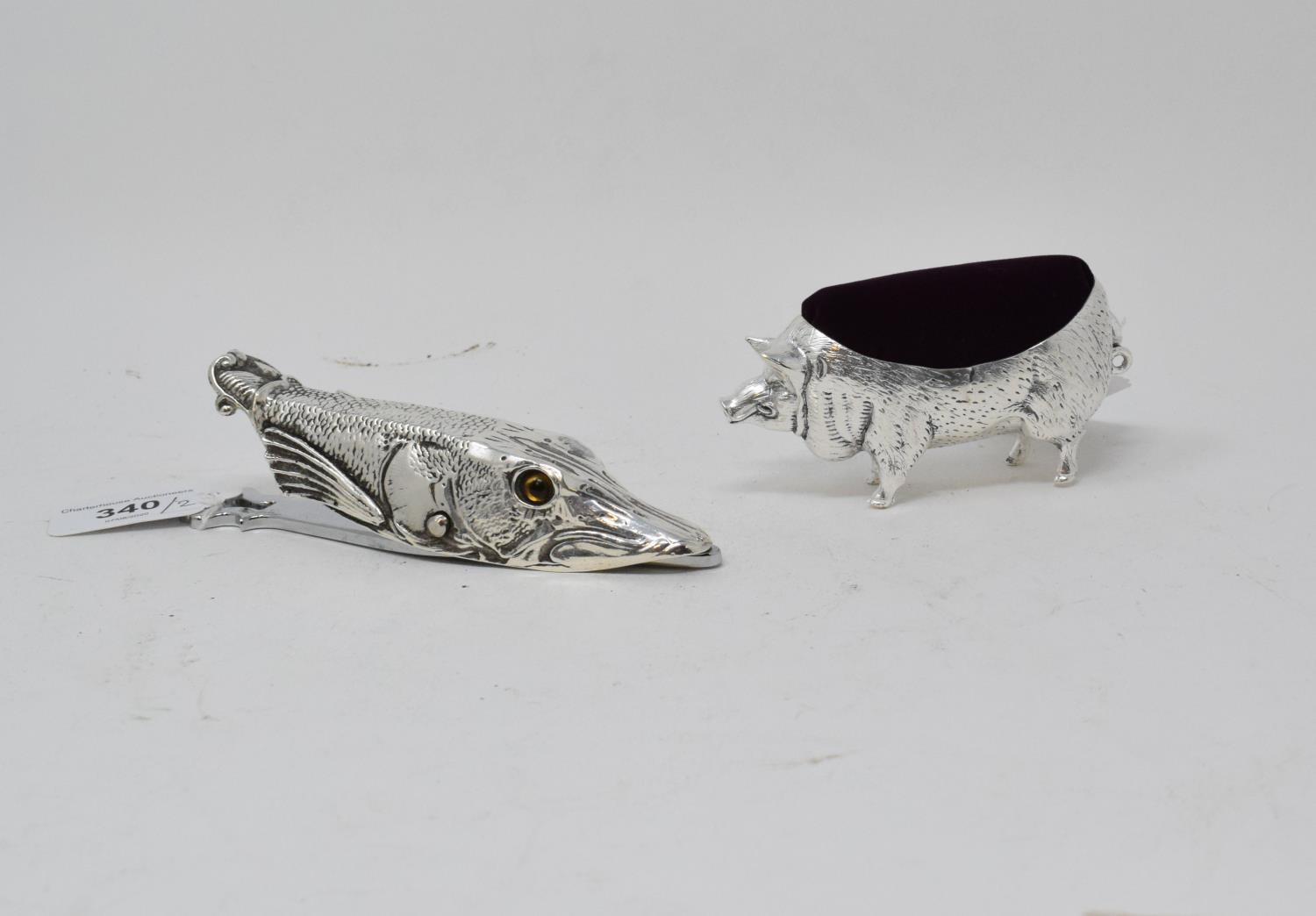 A plated paperclip, in the form of a Pike head, and a pig pin cushion (2) Report by RB Modern