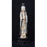 An early 20th century Chinese carved, stained and painted ivory figure, of a lady holding beads