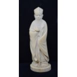 An early 20th century Chinese carved ivory figure, of a sage holding a staff, 19 cm high