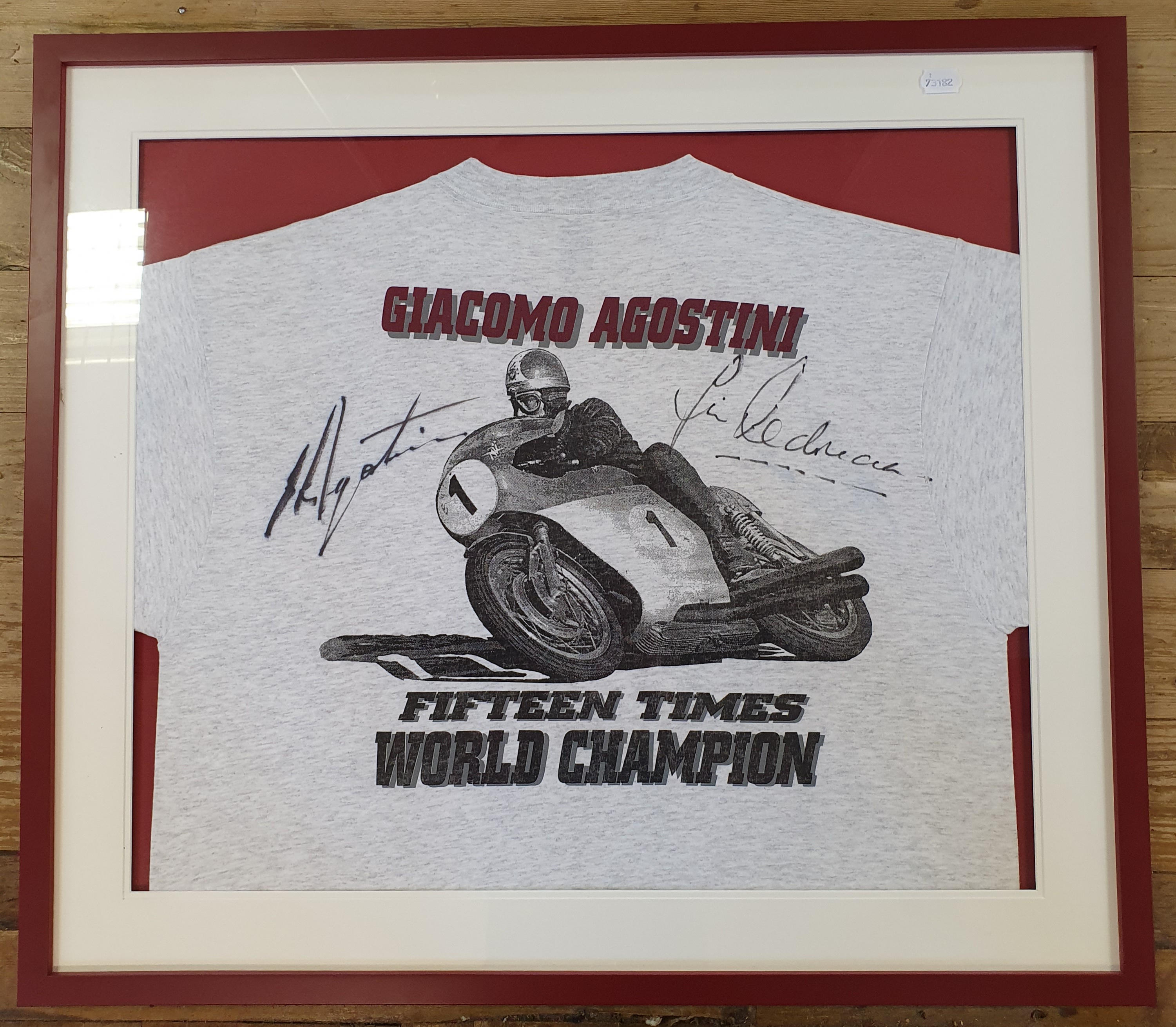 A T-shirt, signed by Giacomo Agostini and Jim Redman to the front and Geoff Duke to the back.