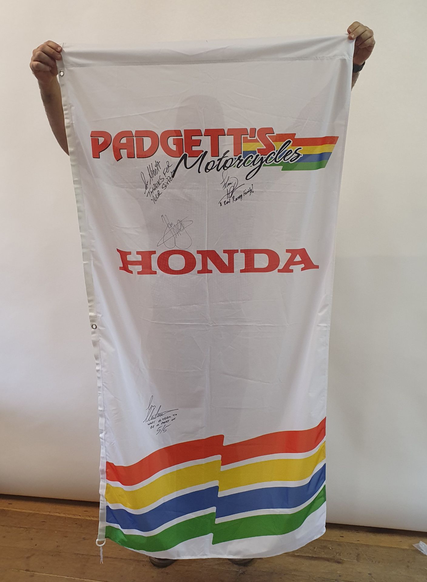 A PADGETT'S HONDA motorcycles banner, with various team signatures including John McGuinness and Ian