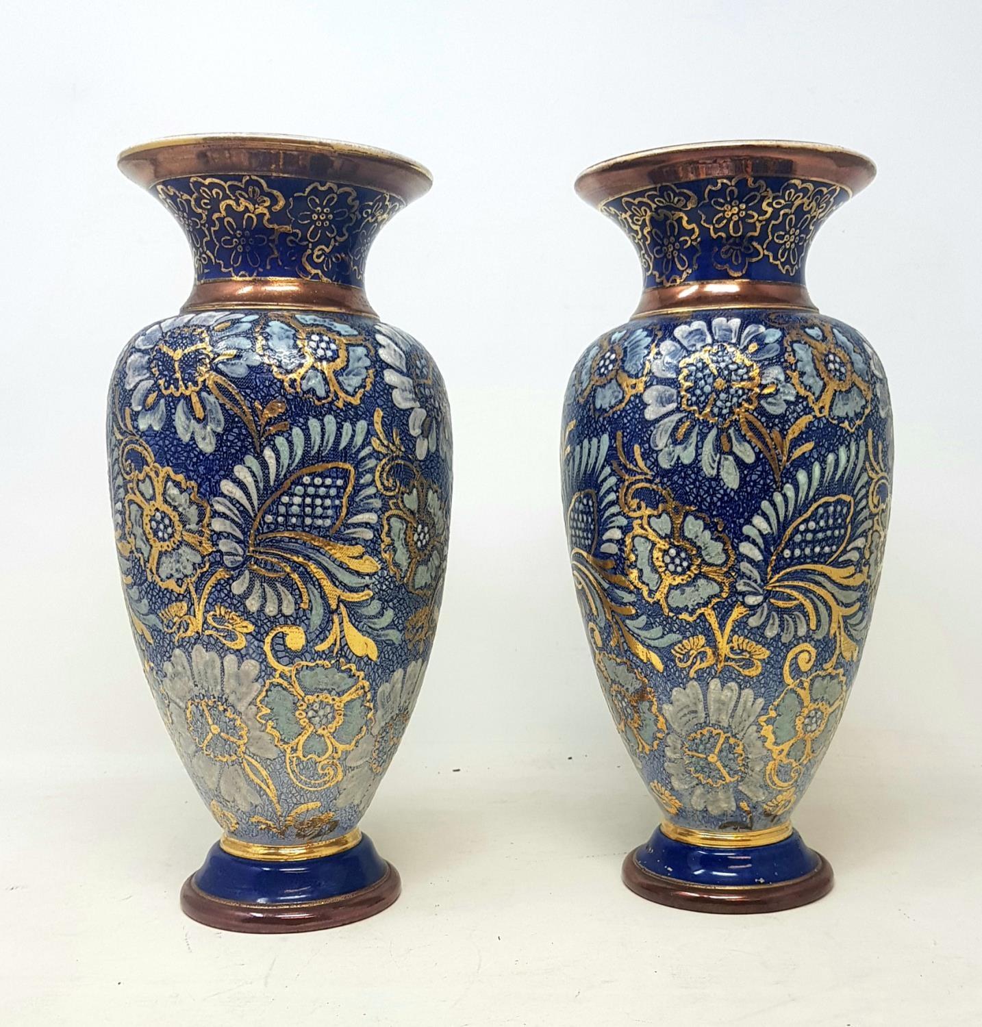 A pair of Royal Doulton stoneware vases, decorated with flowers, 38 cm high