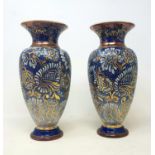 A pair of Royal Doulton stoneware vases, decorated with flowers, 38 cm high
