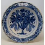 A 19th century Delft plate, decorated flowers, 30 cm diameter