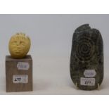 A Inuit school carved rock, 19 cm wide and a carved stone bust, on a wooden base, 16 cm