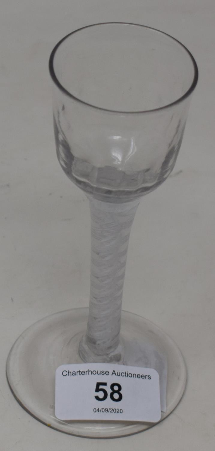 An 18th century wine glass with opaque air twist stem, 14 cm high