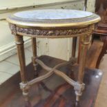 A Louis XVI style gilt occasional table, with a marble inset top, on tapering fluted legs joined