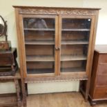 An early 20th century carved oak display cabinet, 127 cm wide