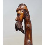 A 19th century one piece hardwood folk art walking stick, handle in the form of bearded man and