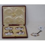 A set of four enamel decanter labels, cased, and another similar