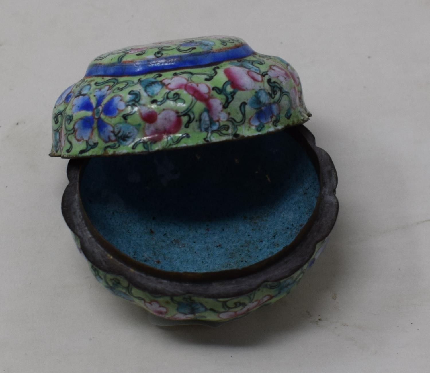 A Canton enamel pot and cover, decorated with flowers on a green ground, 3 cm diameter see images