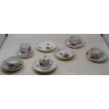 A Meissen cup and saucer, painted with flowers in pink and puce, blue crossed sword mark, and