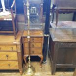 A 1920's walnut chest of three drawers, top with drop leaves, an American wall clock and a