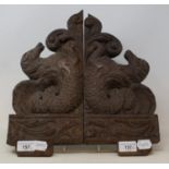 A pair of oak carvings, in the form of horses, 33 cm wide