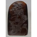 A Chinese hardstone carved pebble, decorated with two figures below a knarled tree, height 8 cm