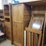 A stripped pine cupboard with a single door, adapted from a larger piece of furniture, 71 cm wide,