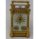 A carriage clock, with repeat, with subsidiary day and month dials, in a brass case, 16 cm high