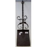 A wrought iron fireside shovel, with scroll decoration, 72 cm