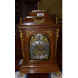 An early 20th century German mantel clock, the 11 cm brass dial with Roman numerals, in an oak case,