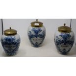 A set of three early 19th century Dutch delft jars, Rappe, Havana and Stokvis, with brass covers, 26